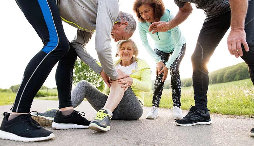 Friends Helping Woman with Knee Injury