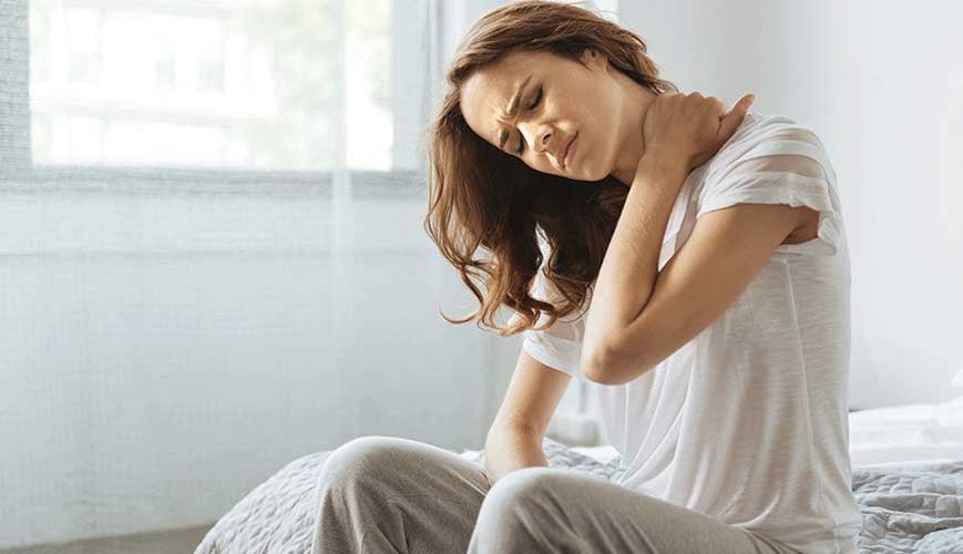 Woman Holding Neck Due To Chronic Neck Pain