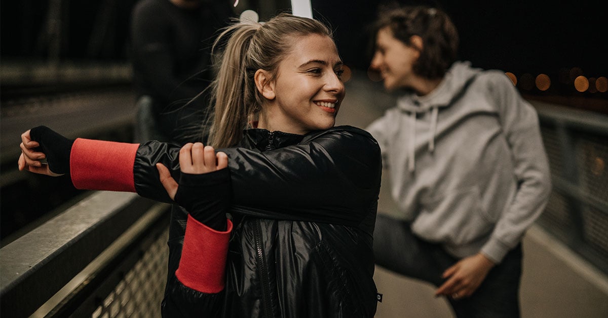 Runners warming up before a turkey trot to avoid injury